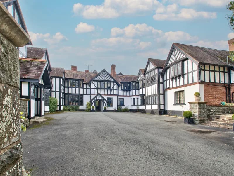 Caer Beris Manor, a black-and-white timbered manor house at the end of its drive